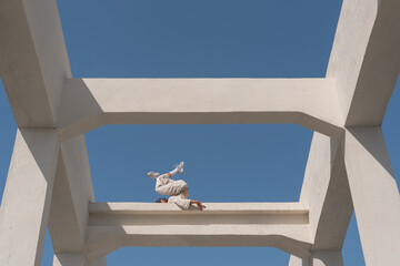 a man in light clothes is dancing in a beautiful light geometric location with lines