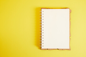spiral notepad on yellow background copyspace mockup