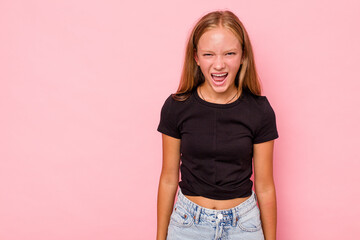 Caucasian teen girl isolated on pink background shouting very angry, rage concept, frustrated.