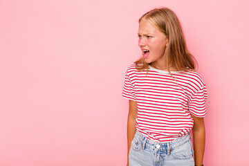 Caucasian teen girl isolated on pink background shouting very angry, rage concept, frustrated.