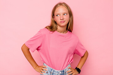 Caucasian teen girl isolated on pink background dreaming of achieving goals and purposes