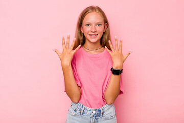 Caucasian teen girl isolated on pink background showing number ten with hands.