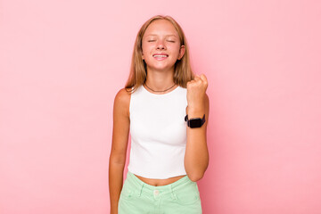 Obraz na płótnie Canvas Caucasian teen girl isolated on pink background celebrating a victory, passion and enthusiasm, happy expression.