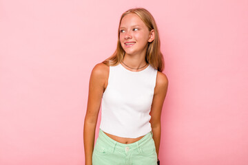 Fototapeta premium Caucasian teen girl isolated on pink background relaxed and happy laughing, neck stretched showing teeth.