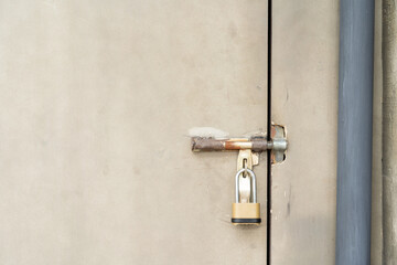 closed door with padlock. metal door texture background with space