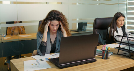 Coworker feeling fatigue after a hard day at work. Woman having lack of ideas. burnout concept.