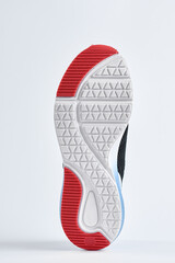 Trendy fashionable sneakers with sole on white background. Stylish sports casual shoes. Creative minimalistic layout with footwear