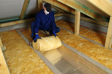 Construction worker thermally insulating house