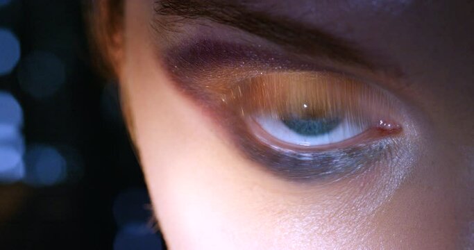 Blue eyes, makeup and glamour cosmetics for beauty and nightlife look. Face zoom portrait of a young person with glitter and shimmer smokey eyeshadow for fashion model show or catwalk with bokeh
