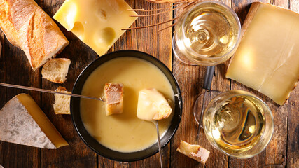 cheese fondue with wine glasses and bread