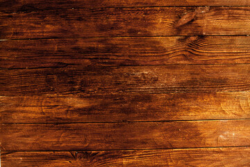 Naklejka premium Vintage brown wood background texture with knots and nail holes. Old painted wood wall. Brown abstract background. Vintage wooden dark horizontal boards. Front view with copy space. Background for des