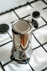 Metal coffee maker for brewing espresso coffee on the stove. Alternative brewing methods