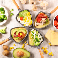 vegetarian raclette cheese party with various vegetables