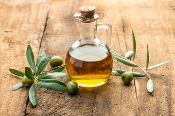 green olives with olive oil. extra virgin olive oil jars on a wooden background. place for text
