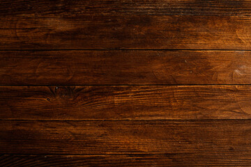 Vintage brown wood background texture with knots and nail holes. Old painted wood wall. Brown abstract background. Vintage wooden dark horizontal boards. Front view with copy space. Background for des