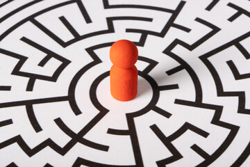 A red figure stands in the center of the labyrinth before choosing a path. The concept of...