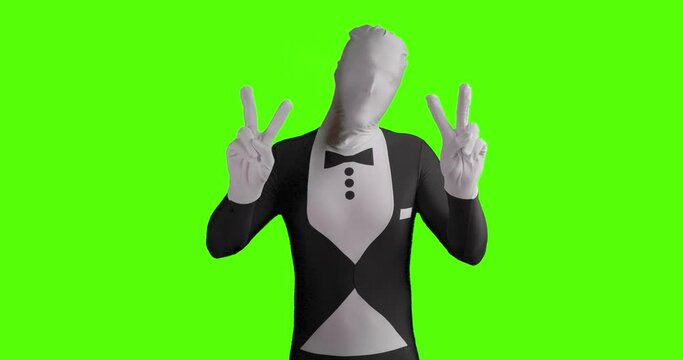 Static shot of a business morphsuit demonstrating for peace and holding peace sign into camera with both hands in front of green background