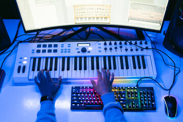 Producer, audio engineer uses a control panel and screen to record a track of a new album in a...