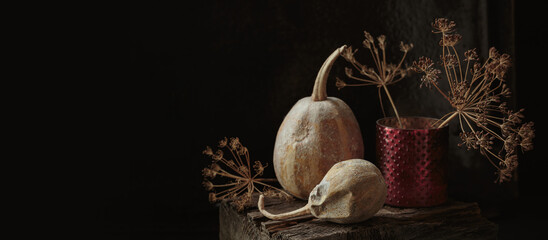 Art autumn dried Pumpkin and flowers thanksgiving still life in a rustic style on a dark wooden...