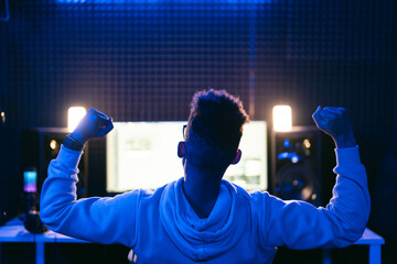 Cheerful Producer, audio engineer uses a control panel to record a track of a new album in a...