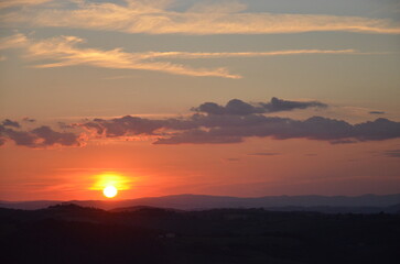 Sunset falling over the beautiful countryside and town of Montepulciano in Tuscany on a bright summer day