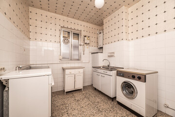 Kitchen with white wooden drawers, stainless steel sink, terrazzo floor, loose appliances and white tiles