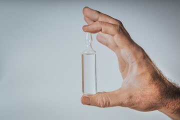 Medical bottle in hand on a white background. Flat lay arrangement with Pharmaceutical industry concept. Pharmacy drugstore. Antibiotic drug resistance. 