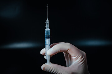 Syringe with medicines in doctor's hand