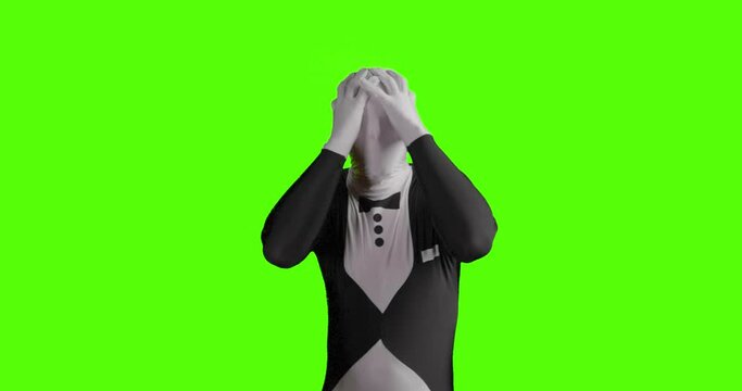 Static shot of angry business morphsuit getting desperate and depressed while gesticulating against green background
