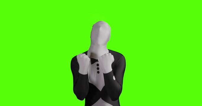 Static shot of a jubilant business morphsuit being happy and joyful against a green background