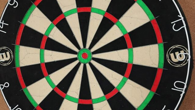 Throwing tight grouping with darts as fun activity.
