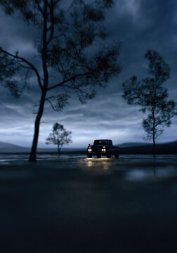 Vintage pickup truck with illuminated headlights in vast landscape with puddles and trees under a dark sky. 3D render.