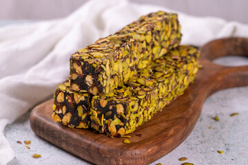 Turkish delight with pistachio on a gray background. Turkish delight with apple flavor. Close-up. local name fistikli fitil lokum