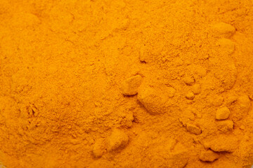 Turmeric powder close-up flat lay. Useful spices, Indian roots and herbs. Medicinal folk ingredients for food.