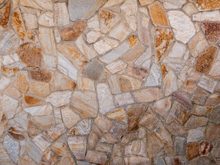Background. Stone wall with a beautiful multicolored texture.