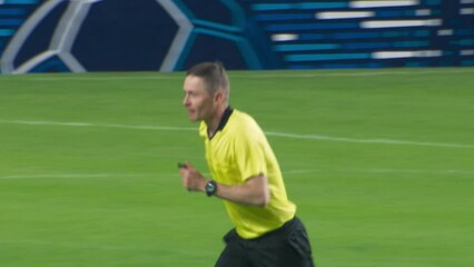 Soccer Football Match Championship: Referee Running on the Field, Whistles, Raising Arm, Showing Sign of Indirect Free Kick, Offside, Corner Kick. Live Sport Broadcast Channel Television Playback