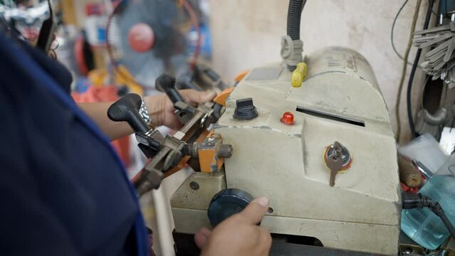Woman Locksmith Is Making A Key Duplicate In The Street Of Bangkok, Thailand. Closeup