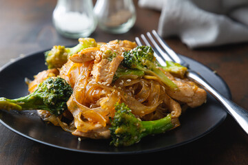 Stir fry, bean noodles with fried chicken fillet and broccoli