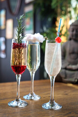 Popular champagne cocktails: pomegranate and rosemary, cotton candy, French 75, in a tall flute...