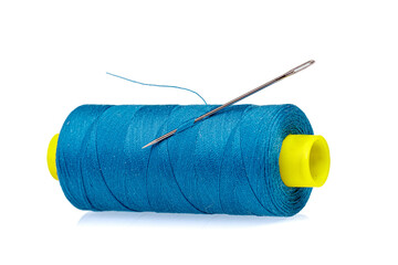 Macro skein of blue thread with a needle on a white background