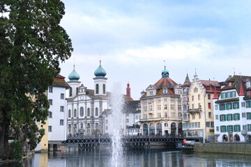 LUCERNE, Switzerland - December 2020: through the spray of the fountain, a beautiful view of the...