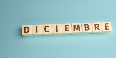 The Spanish word Diciembre (December) built from letters on wooden cubes. High angle view with copy...