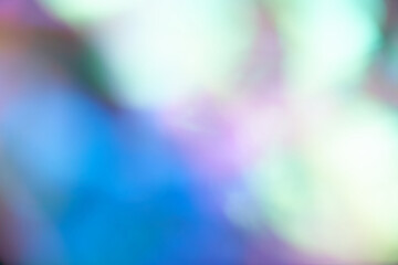 Unfocused holographic colors of mother-of-pearl foil. Blurry holographic abstract background in...