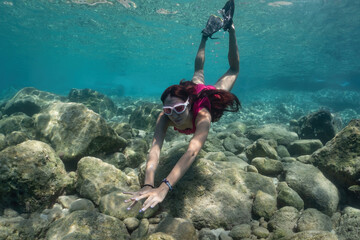 Freediver girl underwater in the sea. Underwater shooting.