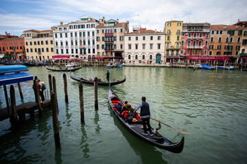 Fototapeta na wymiar People enjoying gondola ride in Venice, Italy