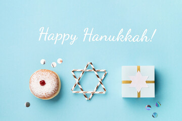 Jewish holiday Hanukkah concept - Hanukkah sweet doughnut with powdered sugar and fruit jam, gift...