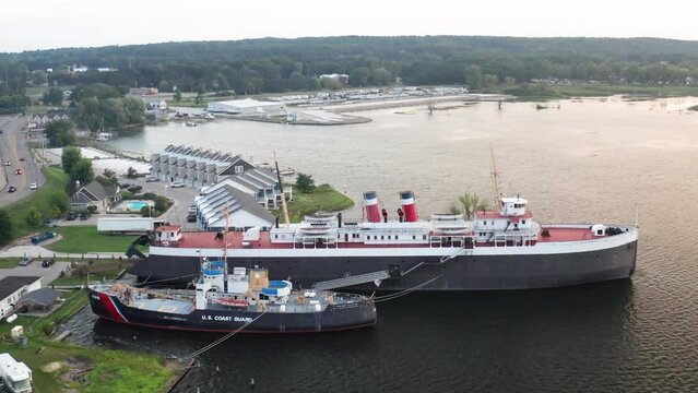 SS City of Milwaukee ghost ship docked in Manistee, Michigan with drone video moving in wide shot.