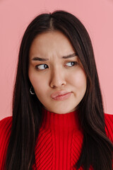 Asian displeased woman frowning and looking aside