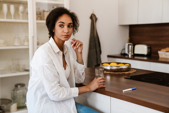 Young Black Woman Being Upset And Taking Abortion Pill At Home