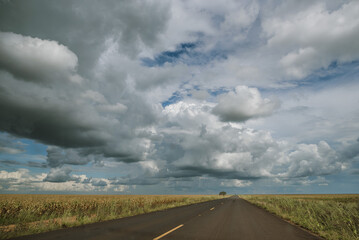 clouds over the highway and cornfield